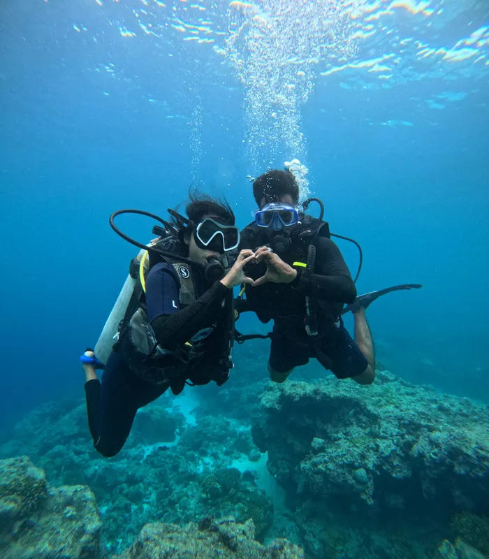 A couple scuba diving over a coral reef in Lakshadweep